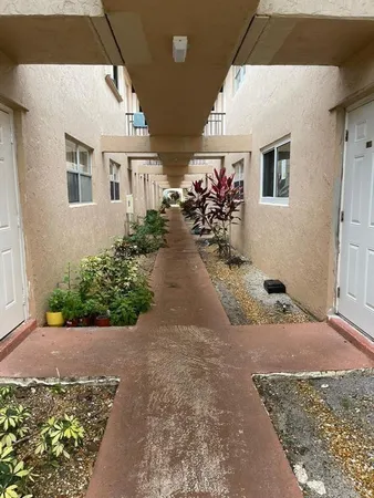 a view of a backyard with potted plants