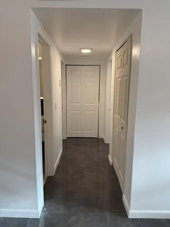 a view of a hallway with wooden shelves