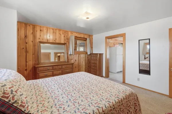 a bedroom with a bed and cabinet