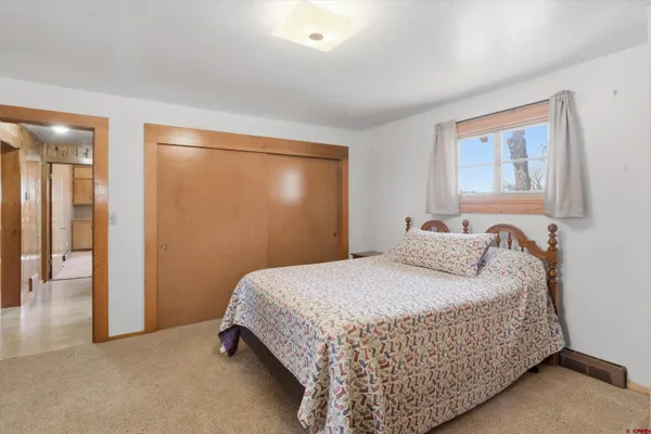 a view of front door with furniture and a window