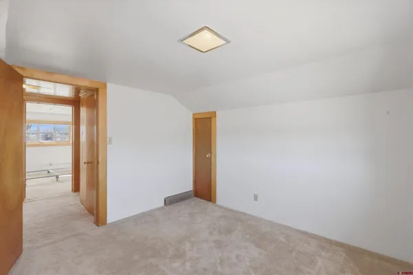 a view of an empty room with windows