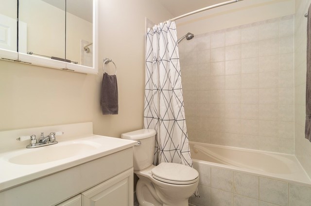 2441 West Harrison Street, Unit 1 Chicago, IL 60612 - Photo 8 of 10 a bathroom with a sink a toilet and shower