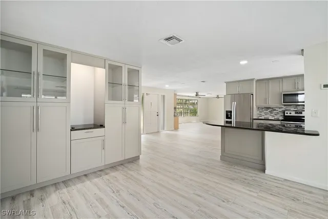 a kitchen with stainless steel appliances a refrigerator and a stove top oven