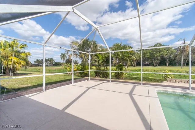 a view of a tennis ground with a big yard