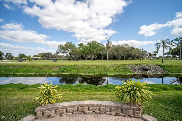 a view of a lake with a house in the background