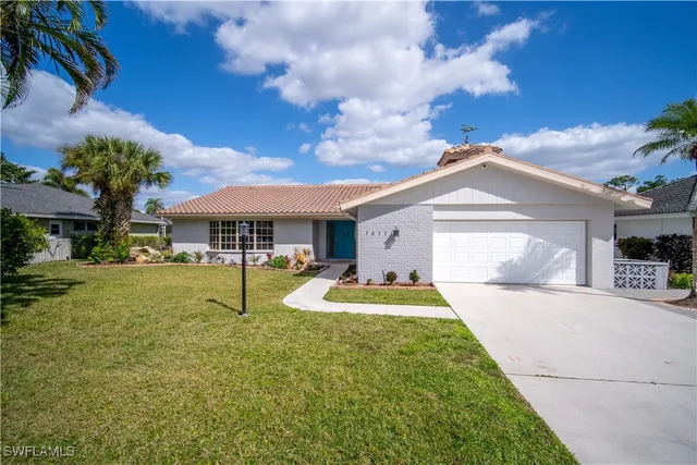 a front view of a house with swimming pool having outdoor seating