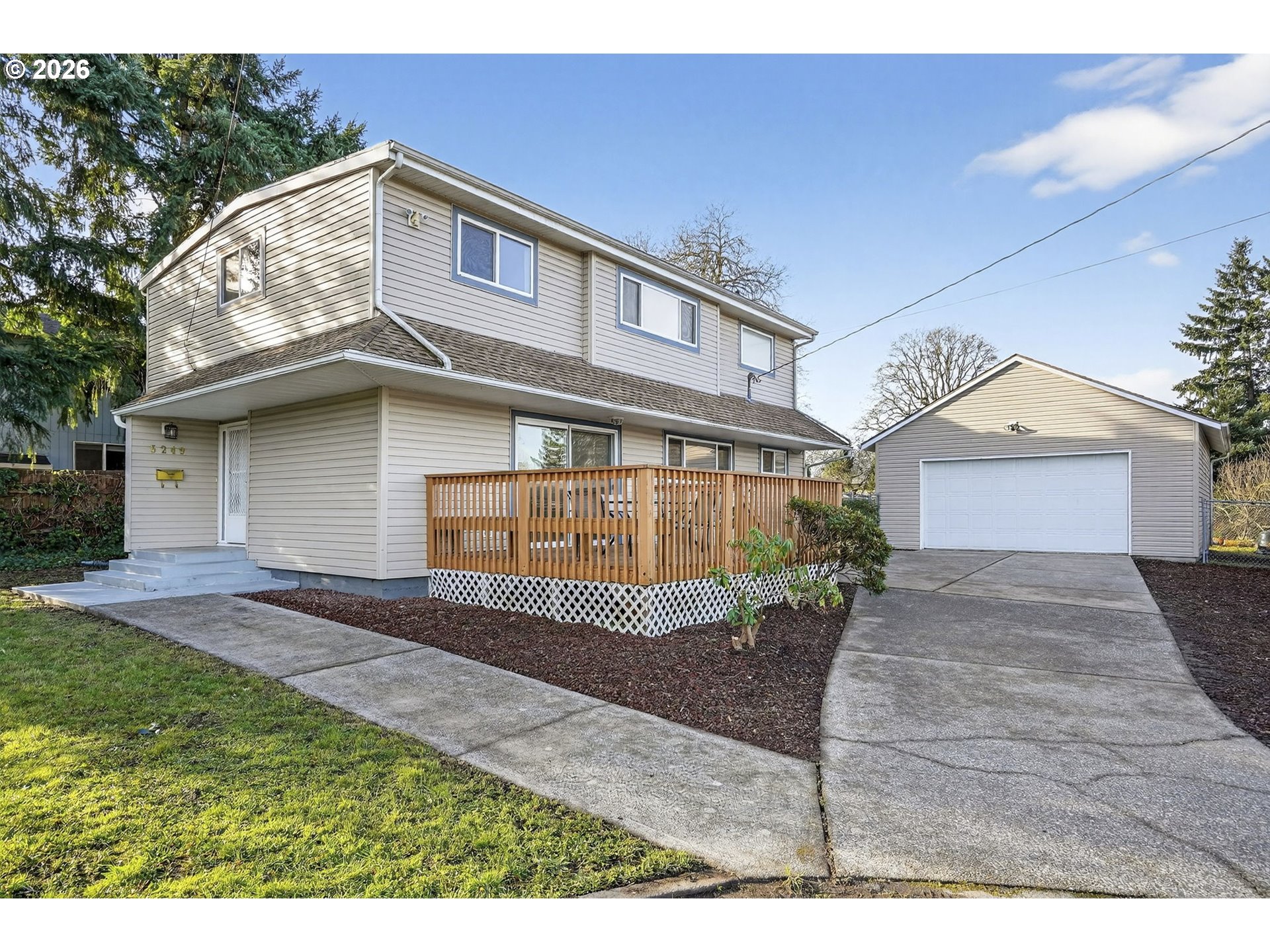 5249 Northeast 45th Place Portland, OR 97218 - Photo 1 of 48 a front view of a house with a yard and garage