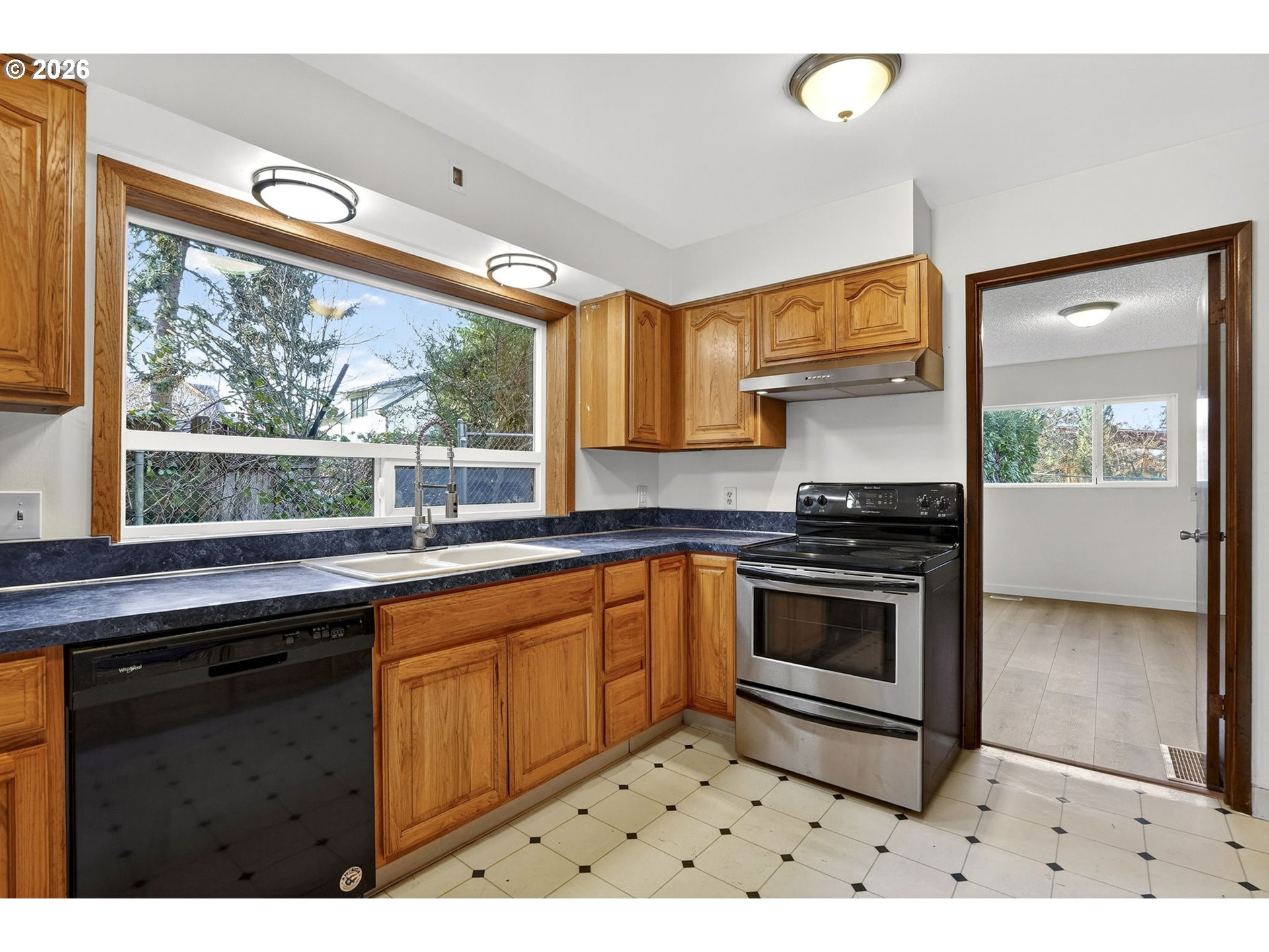 5249 Northeast 45th Place Portland, OR 97218 - Photo 12 of 48 a kitchen with stainless steel appliances a stove sink and window