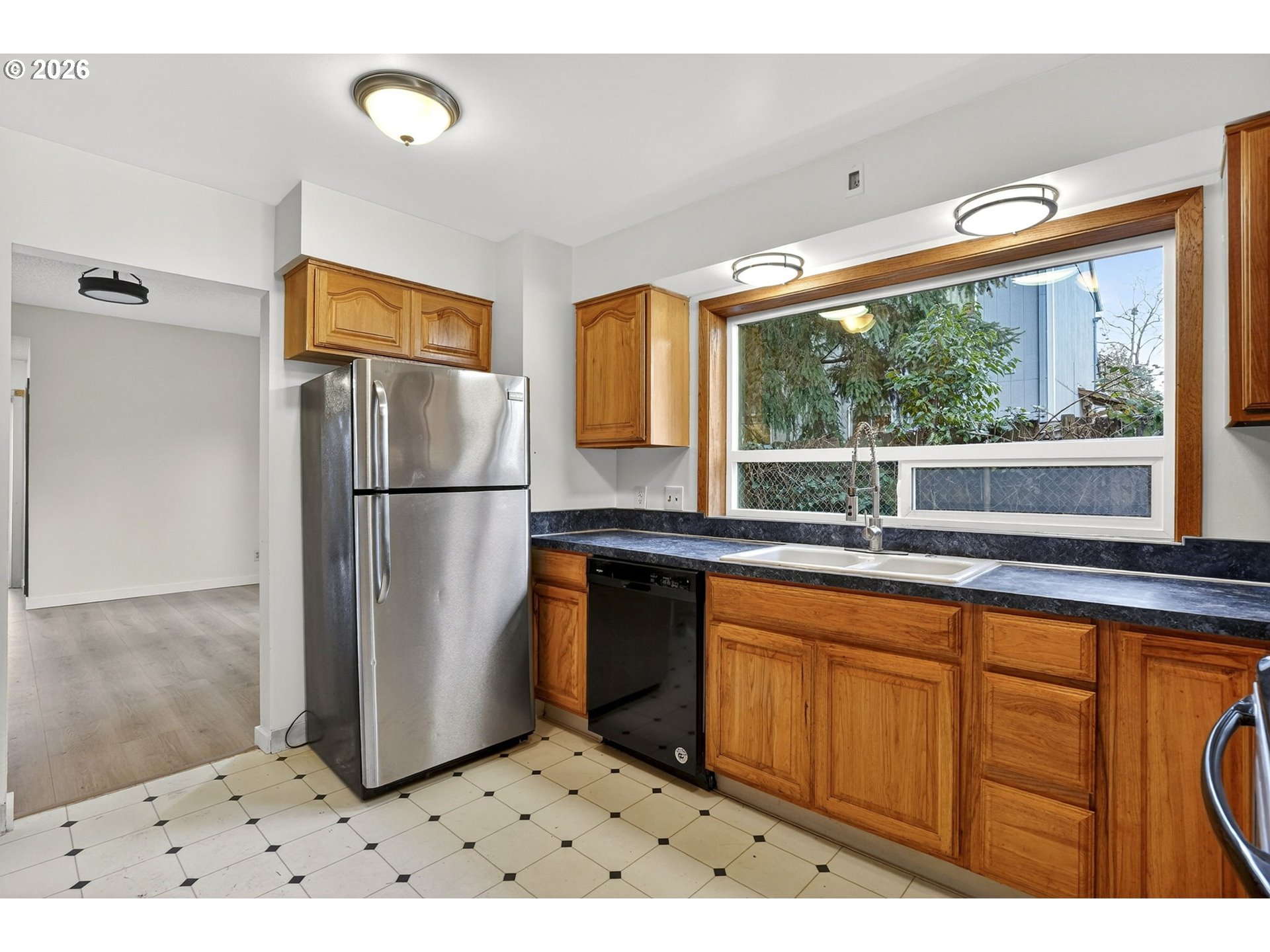 5249 Northeast 45th Place Portland, OR 97218 - Photo 13 of 48 a kitchen with stainless steel appliances granite countertop a refrigerator and a sink