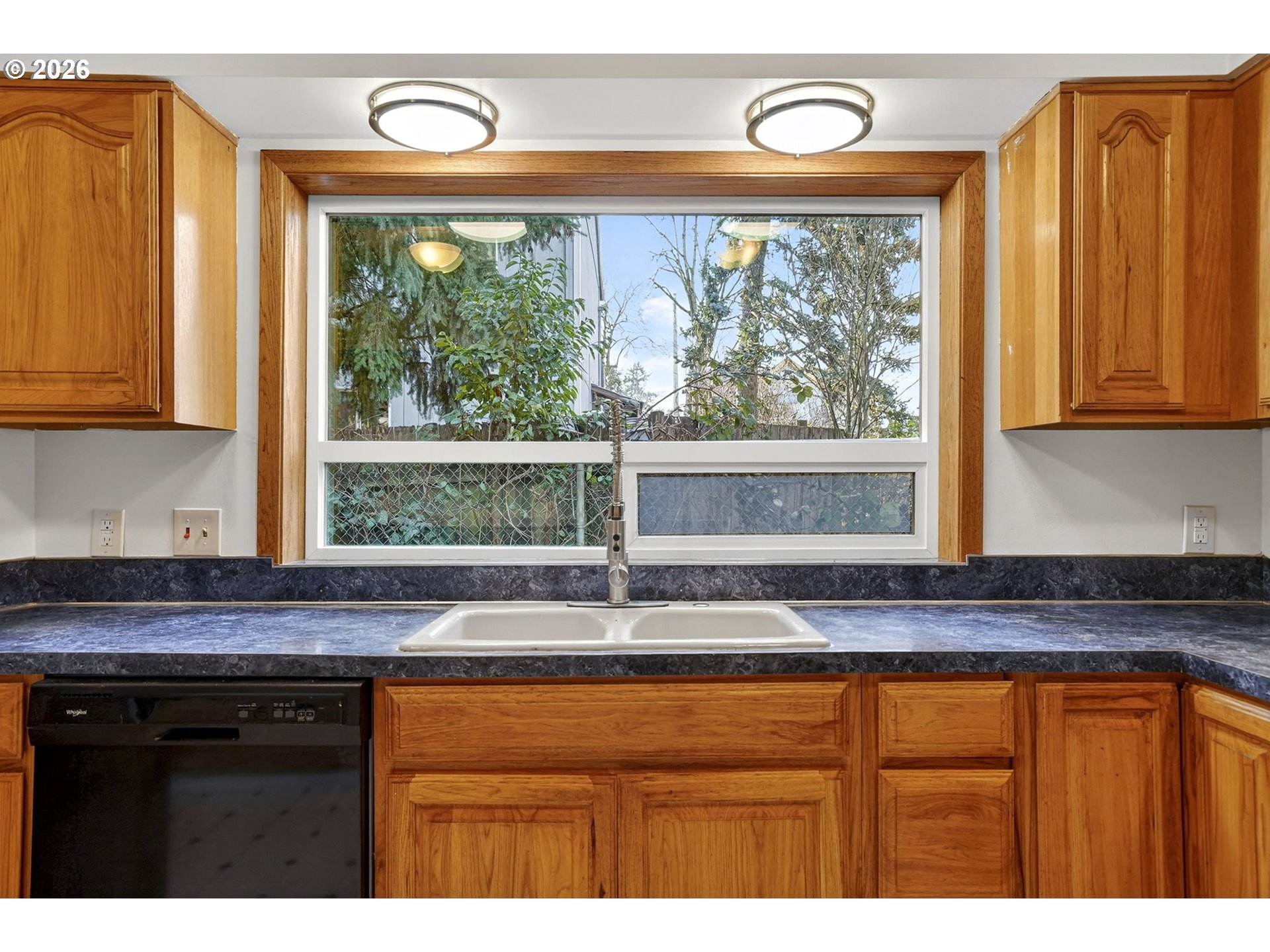 5249 Northeast 45th Place Portland, OR 97218 - Photo 15 of 48 a kitchen with granite countertop a sink and a window