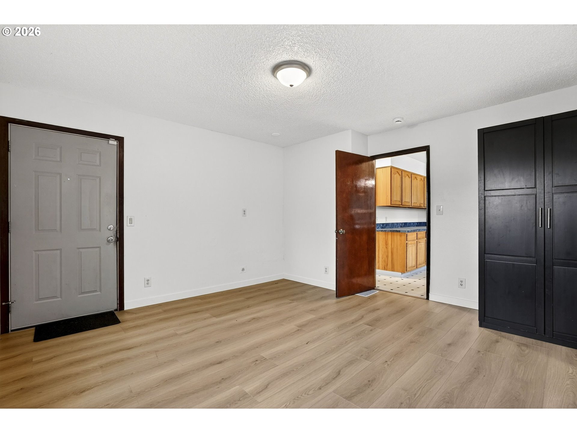 5249 Northeast 45th Place Portland, OR 97218 - Photo 19 of 48 a view of an empty room with wooden floor and a window
