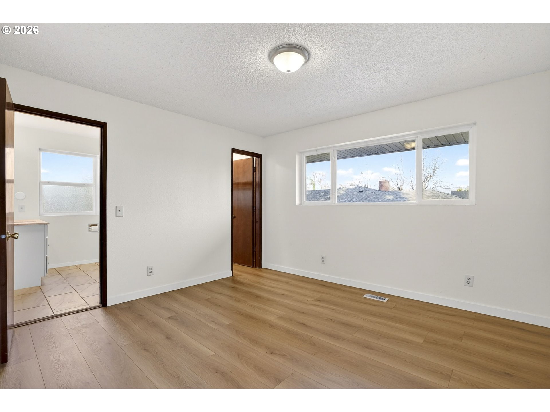 5249 Northeast 45th Place Portland, OR 97218 - Photo 20 of 48 an empty room with wooden floor and windows