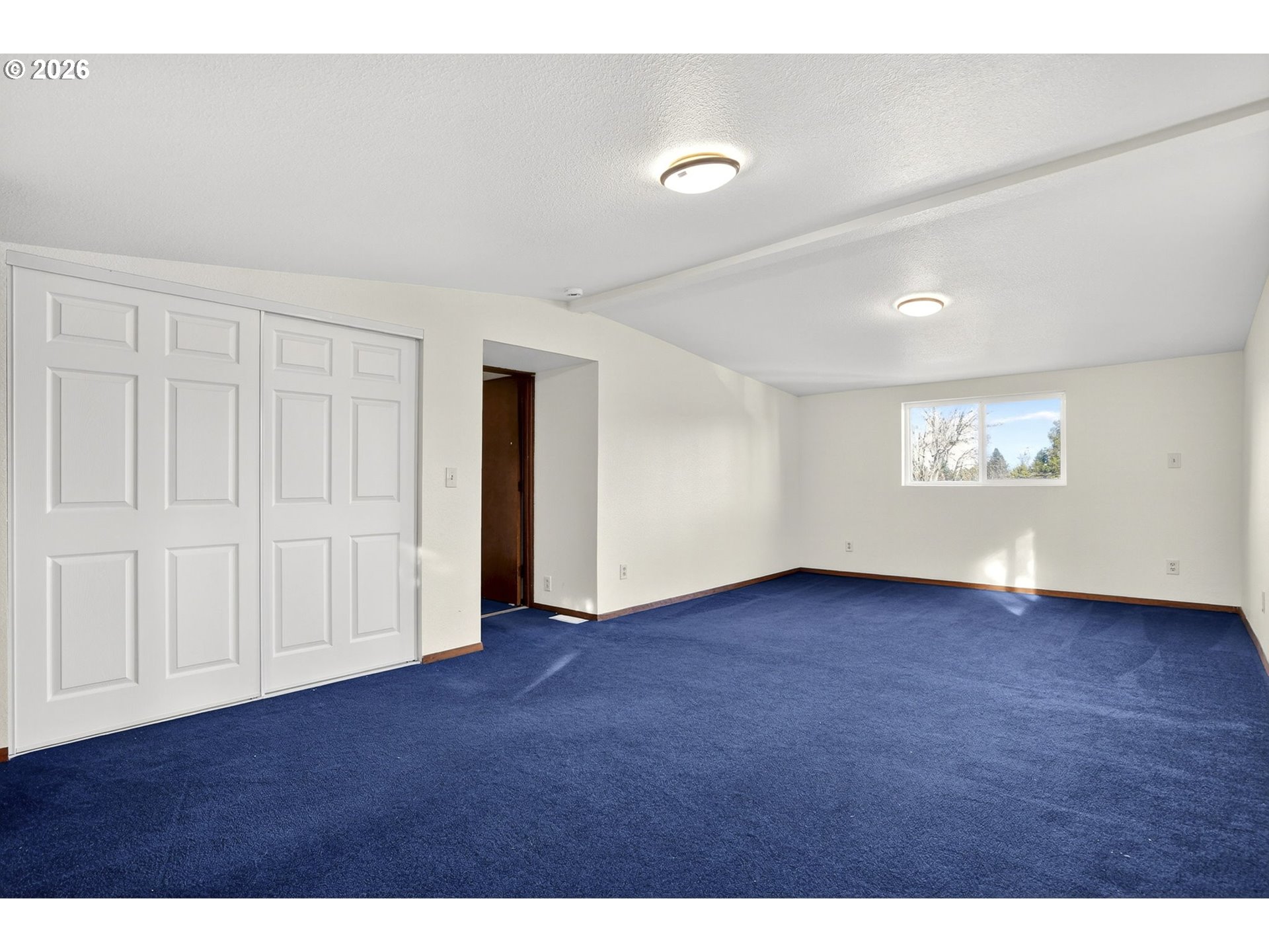 5249 Northeast 45th Place Portland, OR 97218 - Photo 27 of 48 a view of an empty room with a window and wooden floor