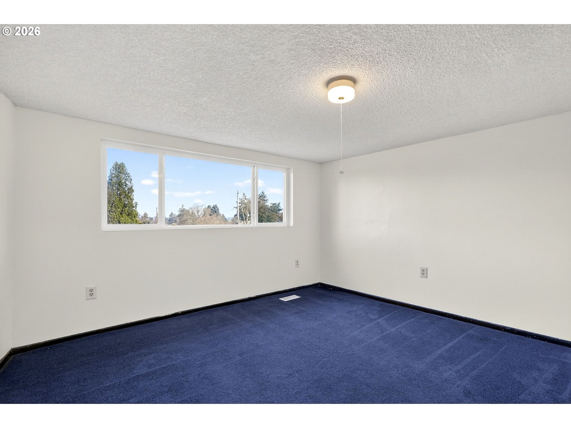 5249 Northeast 45th Place Portland, OR 97218 - Photo 28 of 48 an empty room with wooden floor and window