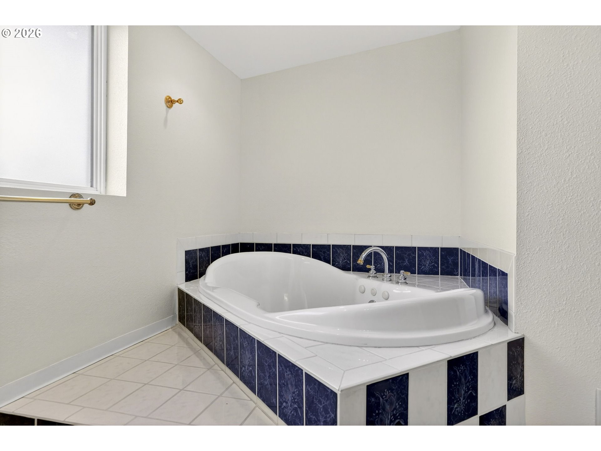 5249 Northeast 45th Place Portland, OR 97218 - Photo 35 of 48 a bathroom with a sink a bathtub and a window