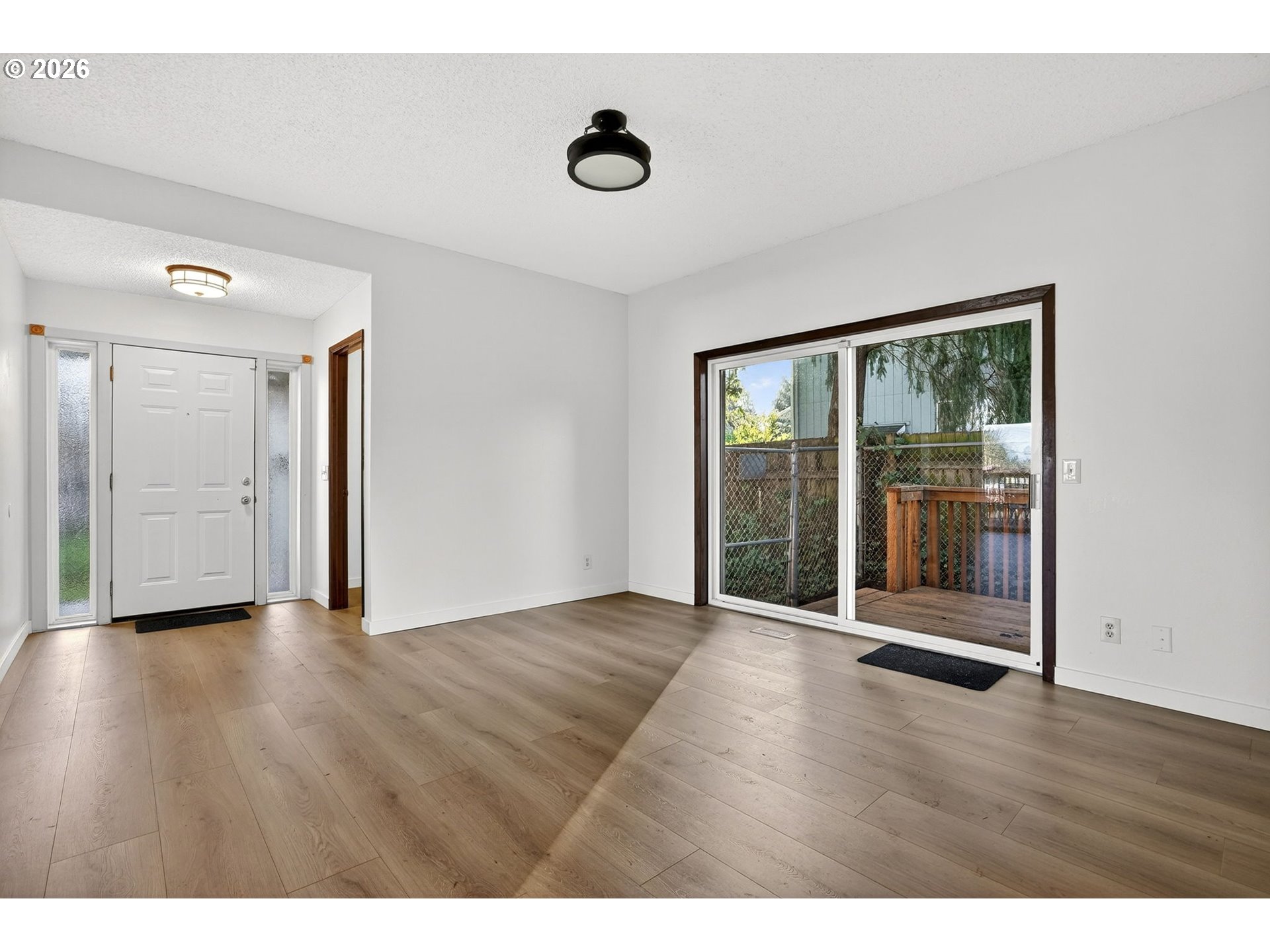 5249 Northeast 45th Place Portland, OR 97218 - Photo 4 of 48 a view of an empty room with wooden floor and a window