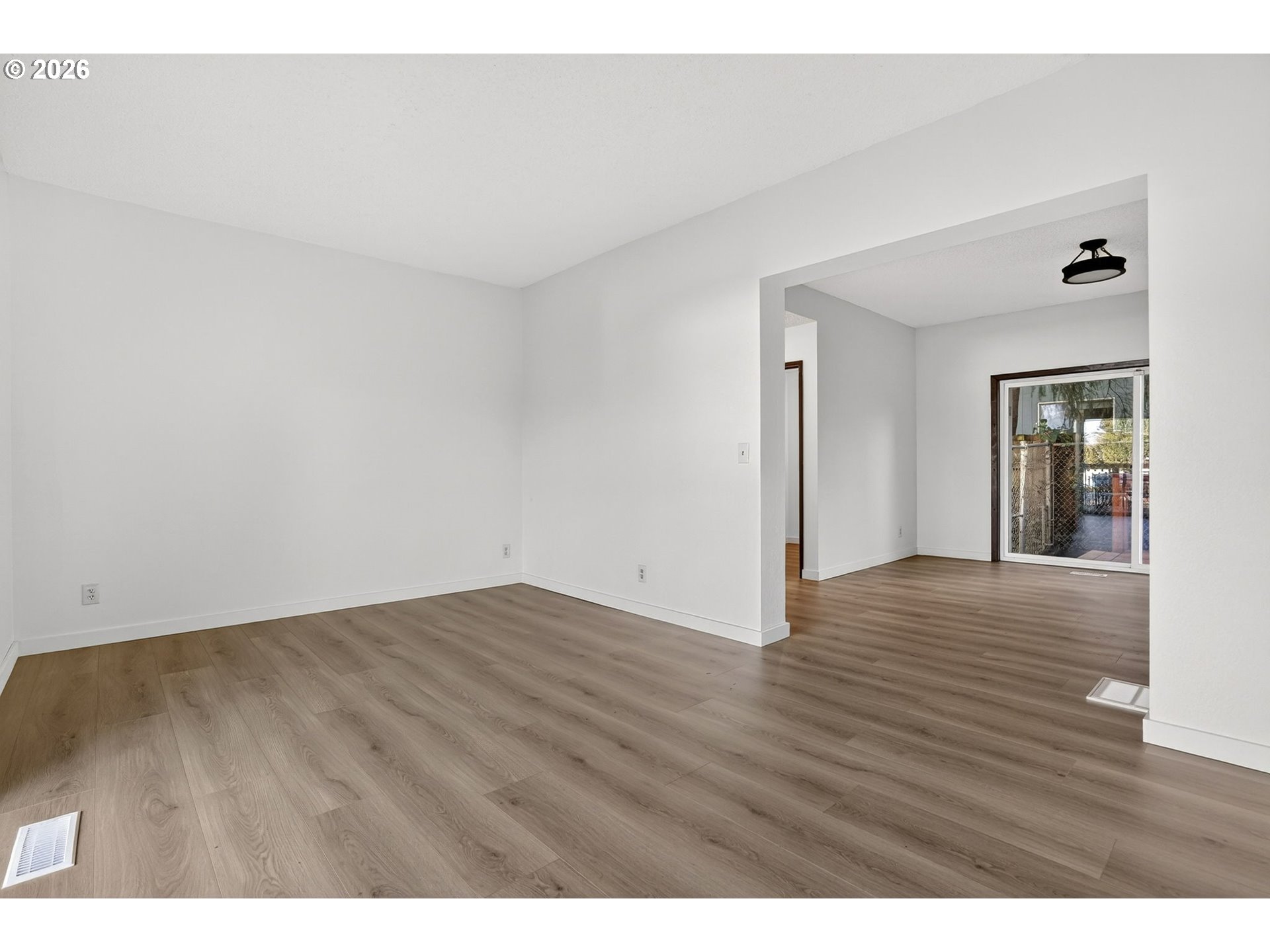 5249 Northeast 45th Place Portland, OR 97218 - Photo 6 of 48 a view of an empty room and wooden floor