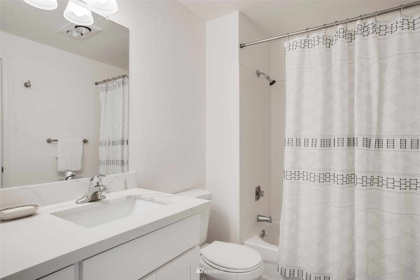 10201 17th Avenue Southwest Seattle, WA 98146 - Photo 11 of 25 a bathroom with a sink a toilet and shower curtain