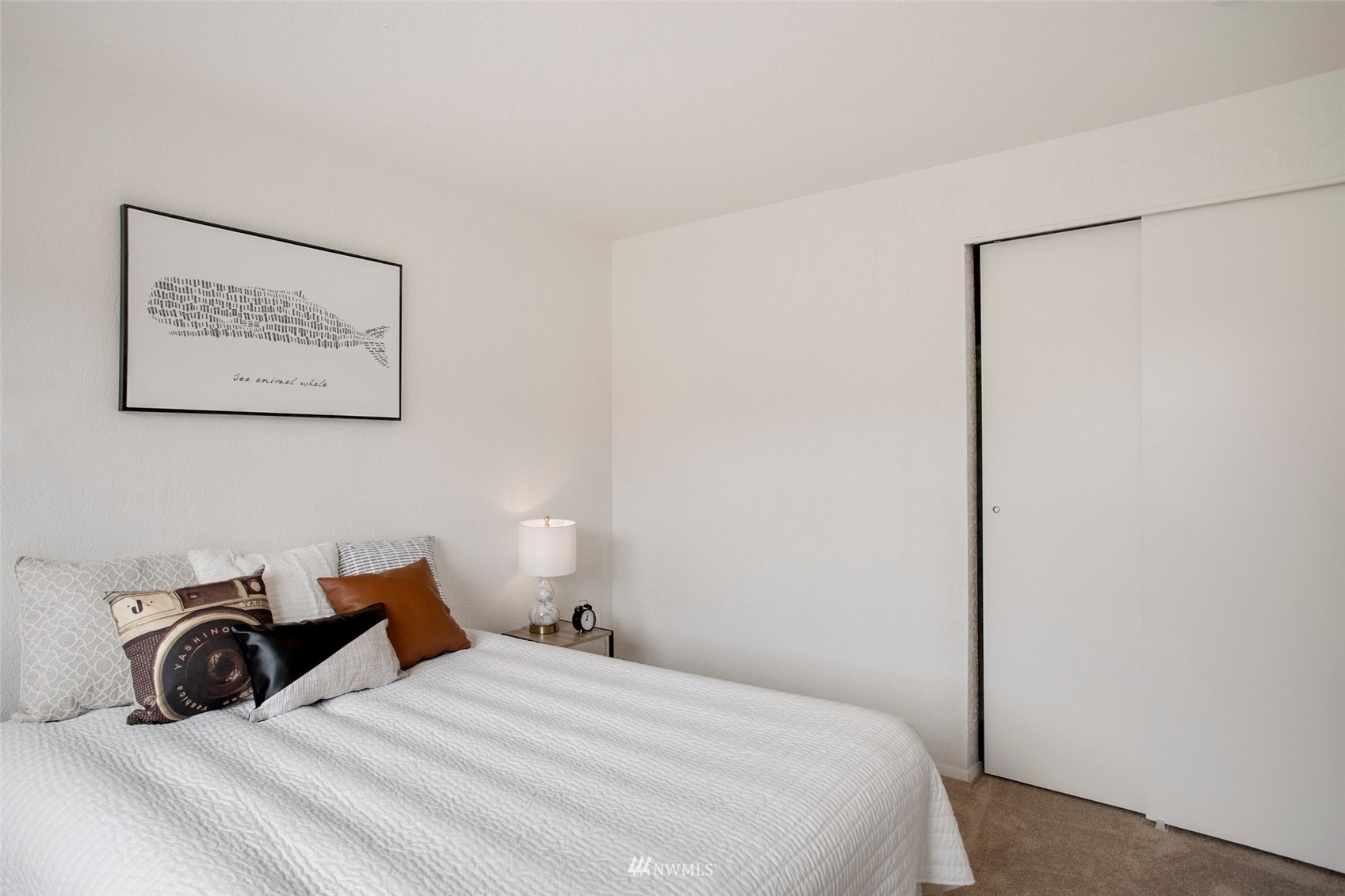 10201 17th Avenue Southwest Seattle, WA 98146 - Photo 13 of 25 a bedroom with a bed and a wall painting