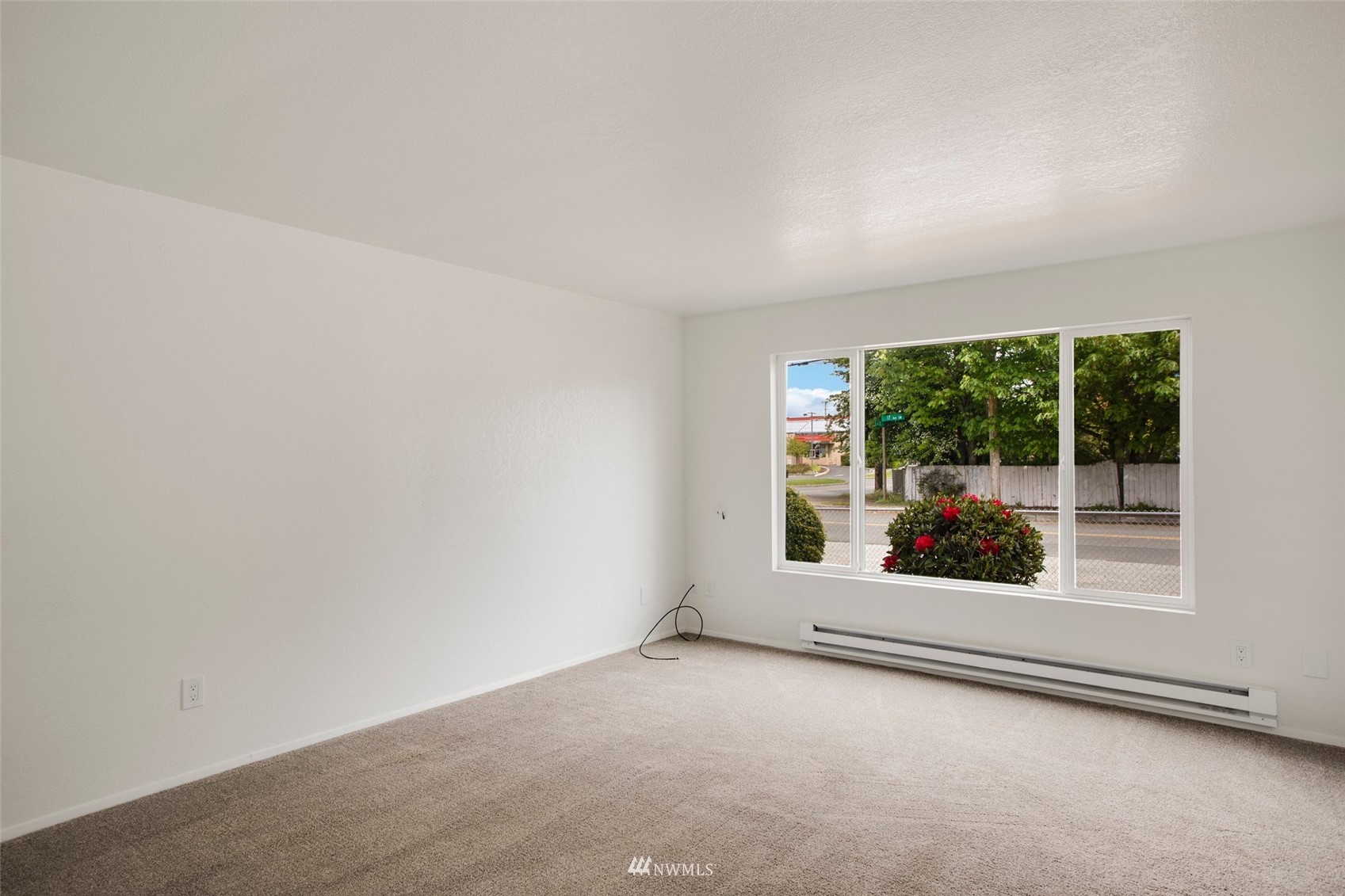 10201 17th Avenue Southwest Seattle, WA 98146 - Photo 16 of 25 an empty room with wooden floor and windows