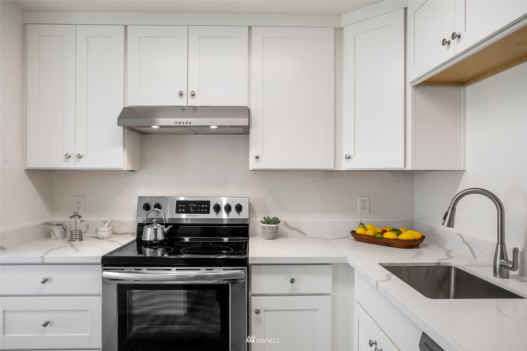 10201 17th Avenue Southwest Seattle, WA 98146 - Photo 8 of 25 a kitchen with stainless steel appliances granite countertop a sink a stove and cabinets