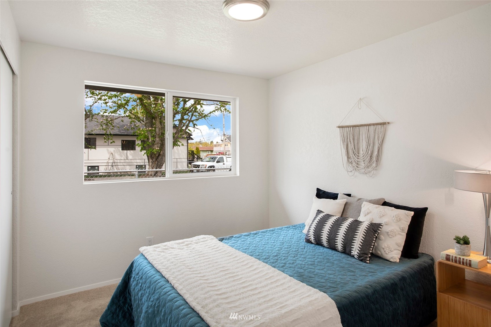 10201 17th Avenue Southwest Seattle, WA 98146 - Photo 10 of 25 a bedroom with a bed and a window