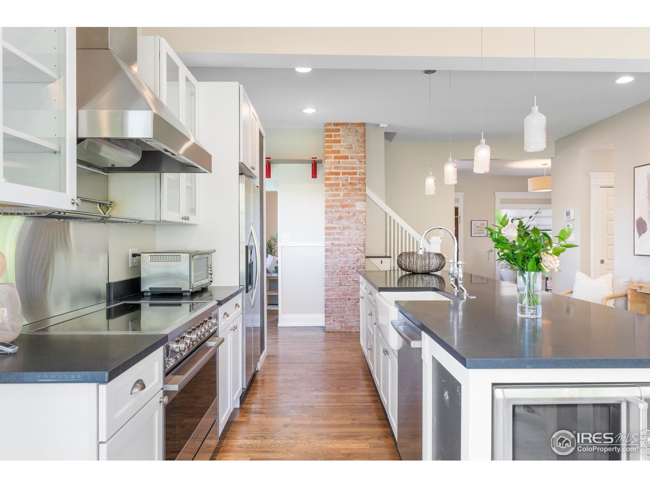 721 9th Street Boulder, CO 80302 - Photo 11 of 40 a kitchen with stainless steel appliances kitchen island granite countertop a stove a sink and a refrigerator