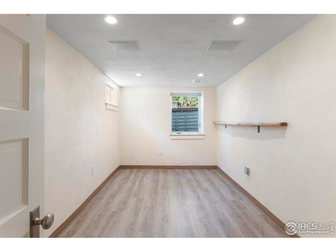 721 9th Street Boulder, CO 80302 - Photo 24 of 40 an empty room with wooden floor and windows