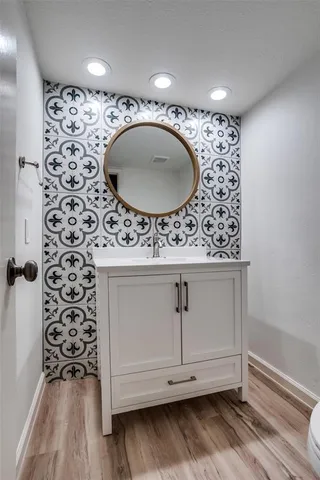 a bathroom with a sink and a mirror