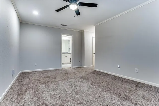 an empty room with fan and windows