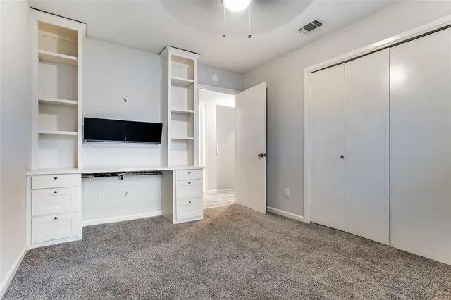 a view of kitchen with white cabinets