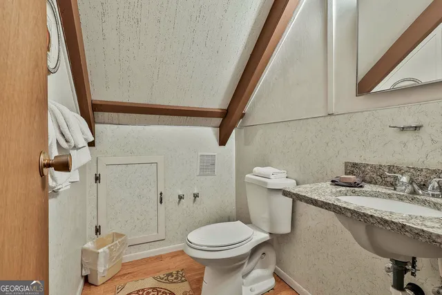 a bathroom with a sink a toilet and a shower