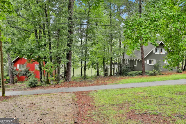 a backyard of a house with lots of green space and fountain