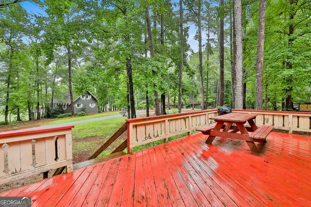 swimming pool view from a balcony with couple of trees