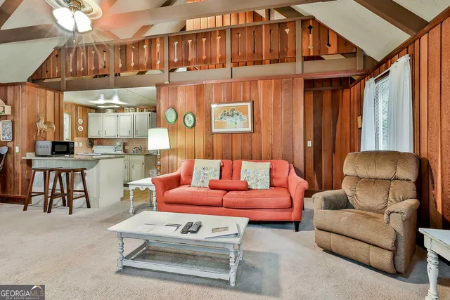 a living room with furniture a fireplace and a chandelier