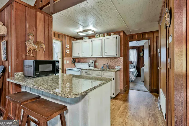 a kitchen with a refrigerator a sink and a cabinets