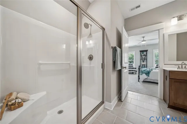 a bathroom with a tub shower and a sink