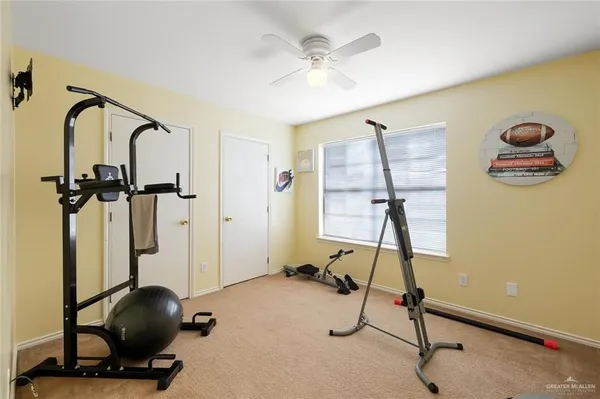 a room with gym equipment and windows