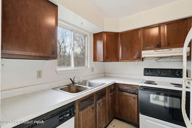 a kitchen with stainless steel appliances a sink stove and cabinets