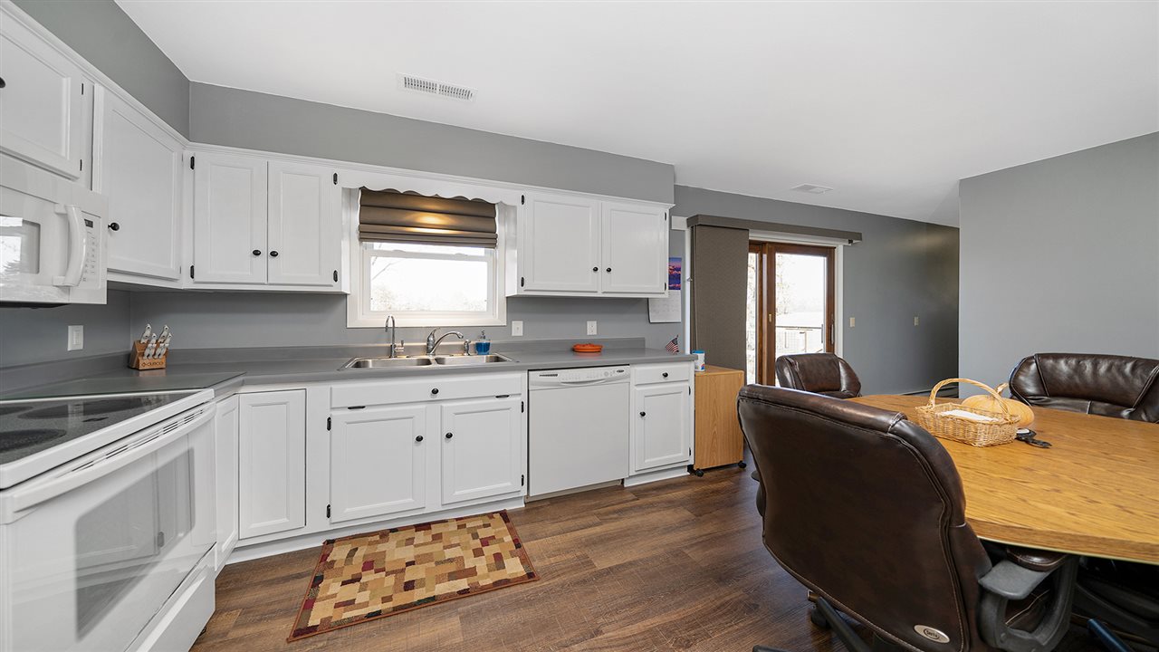 1989 Grand Detour Road Dixon, IL 61021 - Photo 6 of 39 a kitchen with granite countertop a sink white cabinets and white appliances