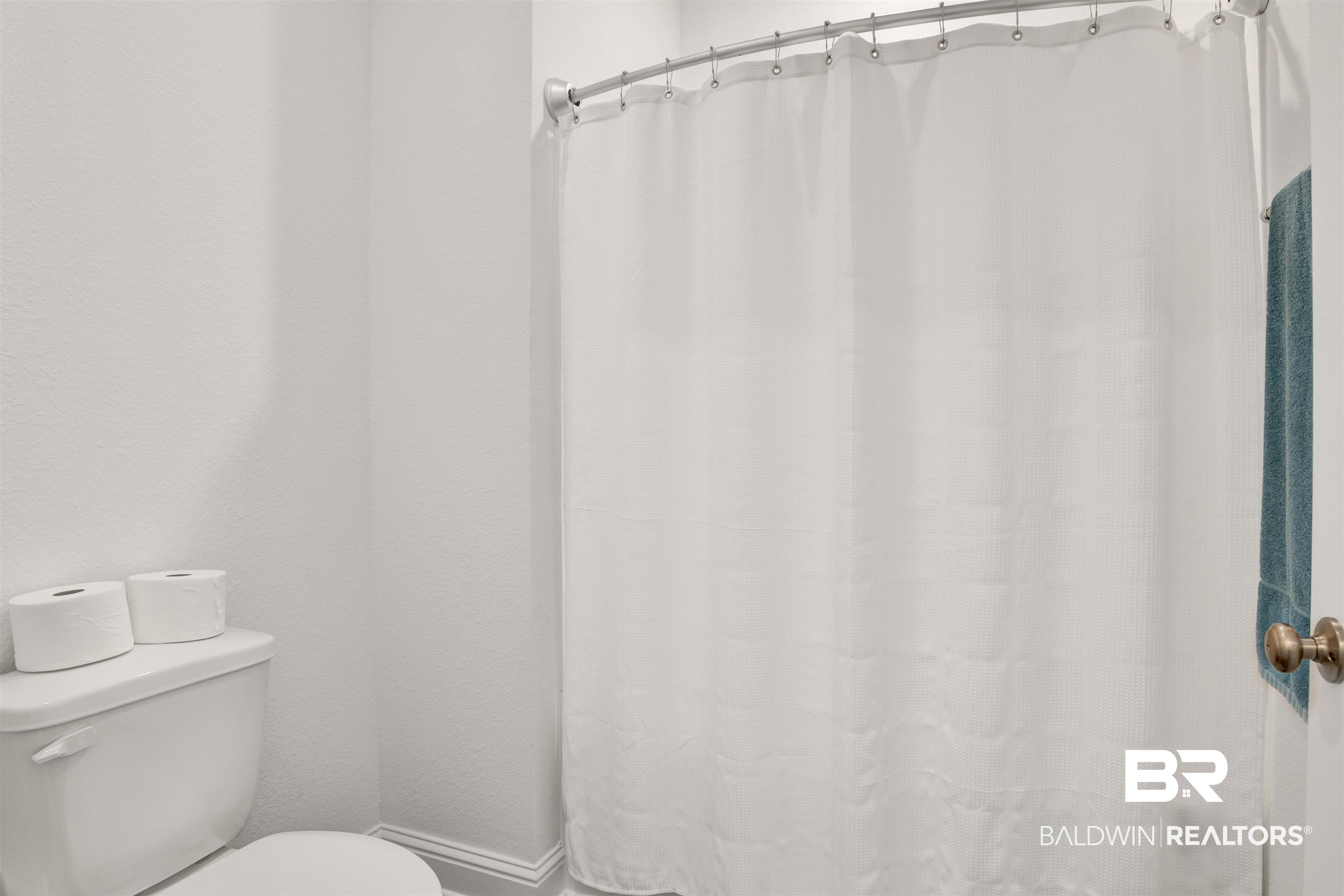 594 Shepard Street Gulf Shores, AL 36542 - Photo 7 of 51 Full bathroom with a shower with curtain and toilet