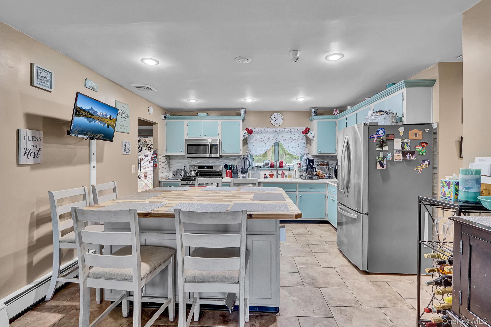 98 Granny Road Farmingville, NY 11738 - Photo 5 of 24 a kitchen with stainless steel appliances granite countertop a refrigerator and a stove top oven