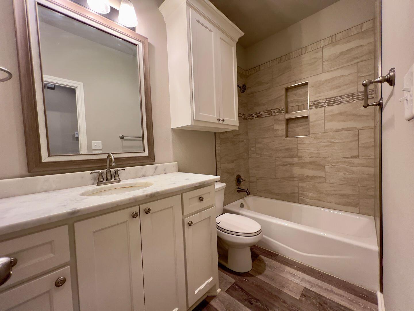 7817 57th Street Lubbock, TX 79407 - Photo 18 of 21 a bathroom with a sink and a mirror