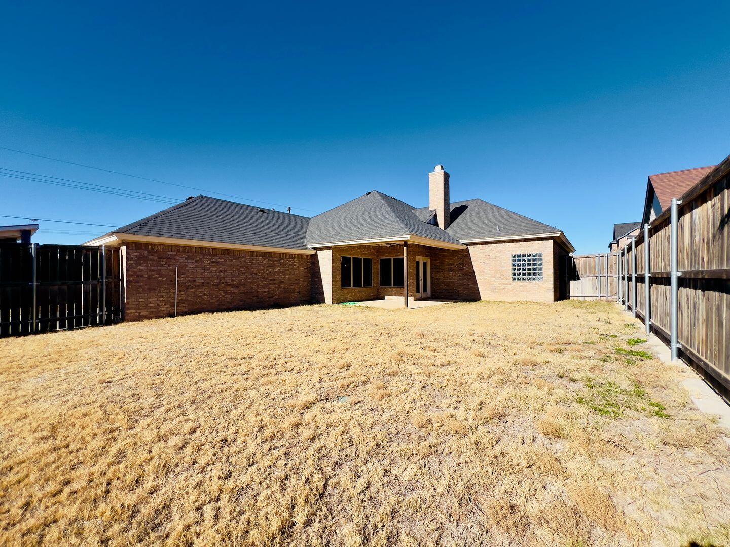 7817 57th Street Lubbock, TX 79407 - Photo 20 of 21 a front view of a house with a yard