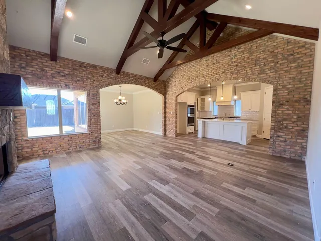 a view of a hall with wooden floor