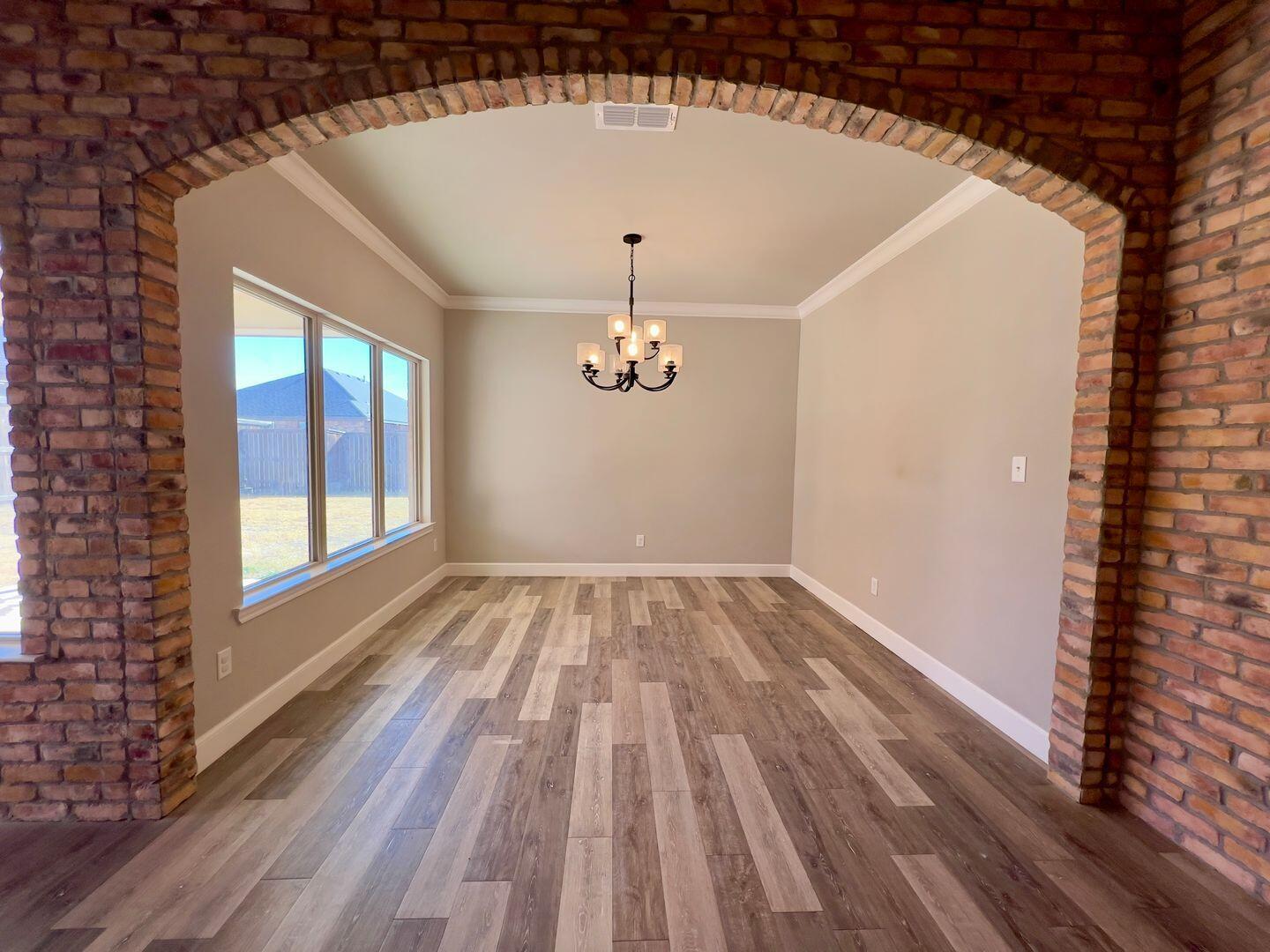 7817 57th Street Lubbock, TX 79407 - Photo 6 of 21 a view of empty room with wooden floor and fan