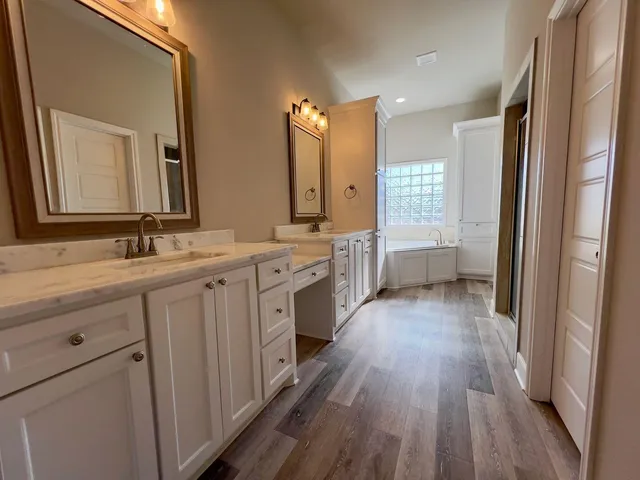 a bathroom with a double vanity sink a mirror and a shower
