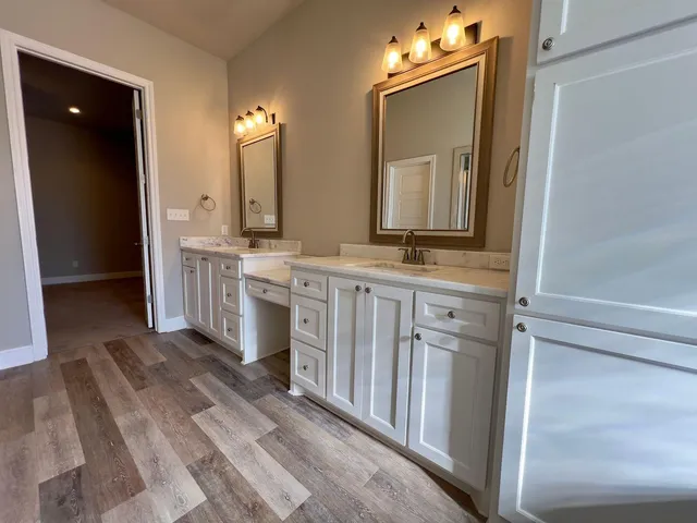 a bathroom with a double vanity sink and mirror