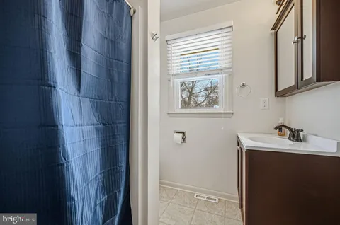 a bathroom with a sink a toilet and a window
