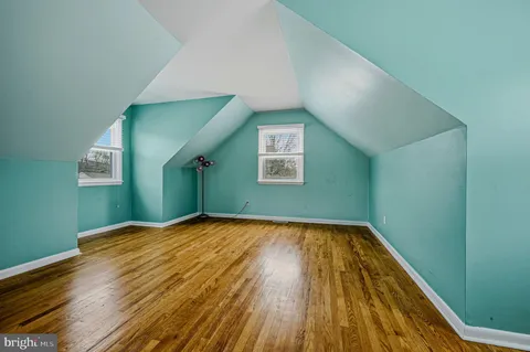 a view of a room with wooden floor and window